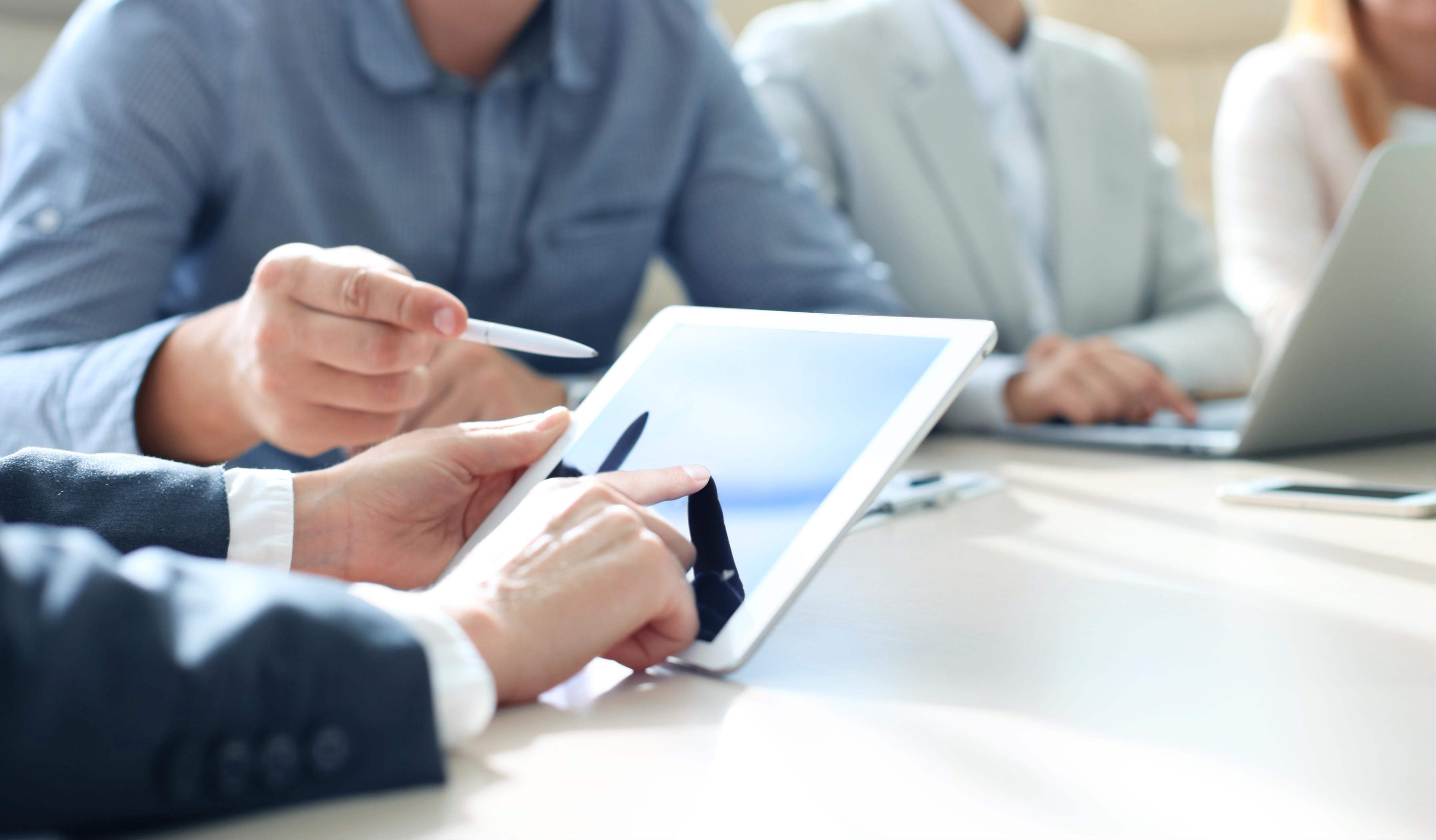Looking at a tablet during a meeting
