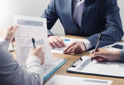 Business men collaborating at a desk