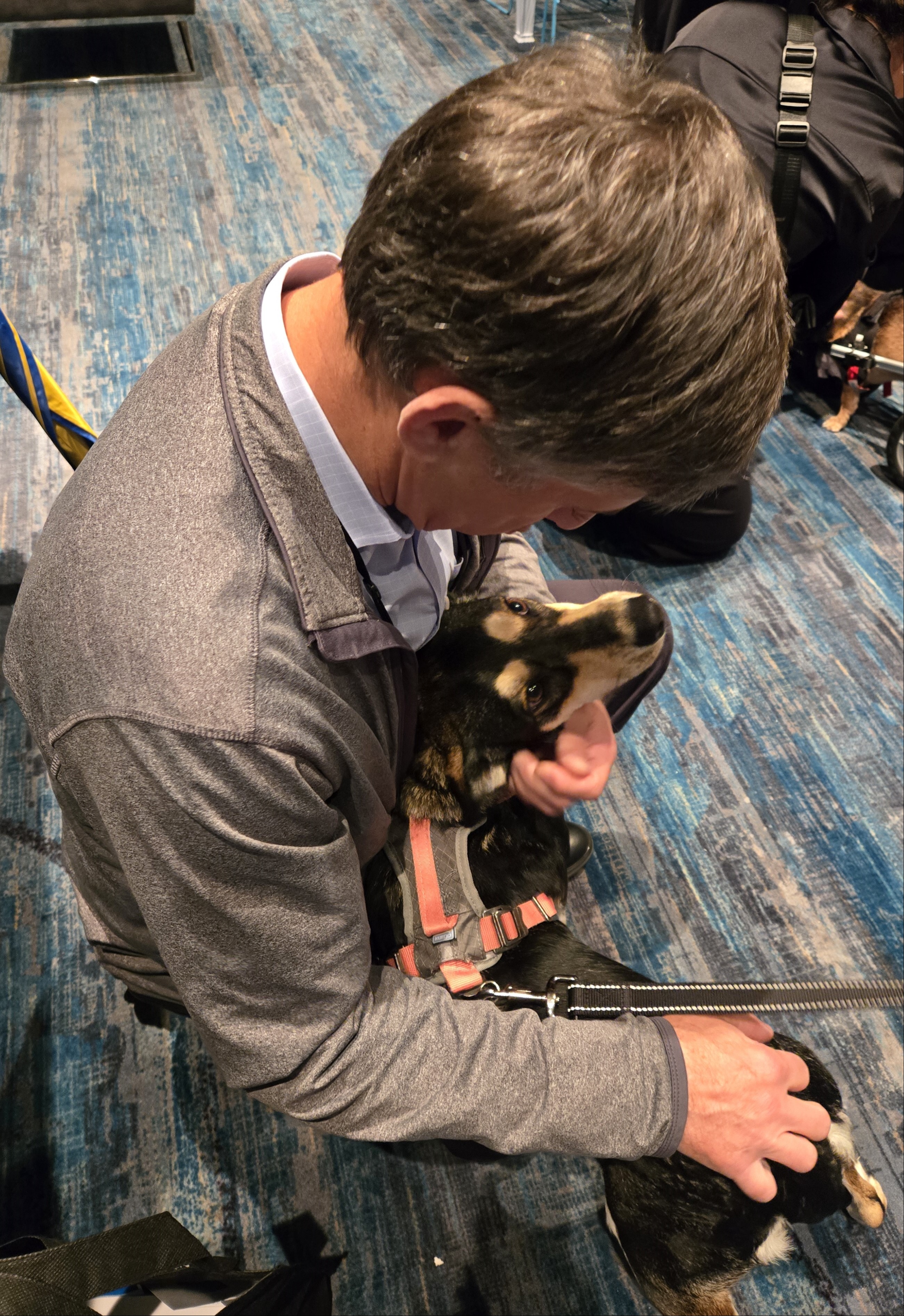 David Santoro petting a small, cute puppy