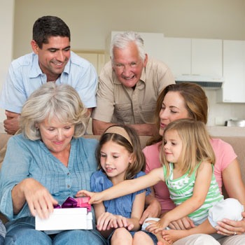 Family smiling together on the couch