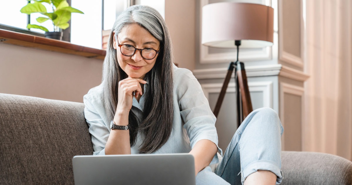 Older woman doing research on how to plan for retirement on her laptop at home