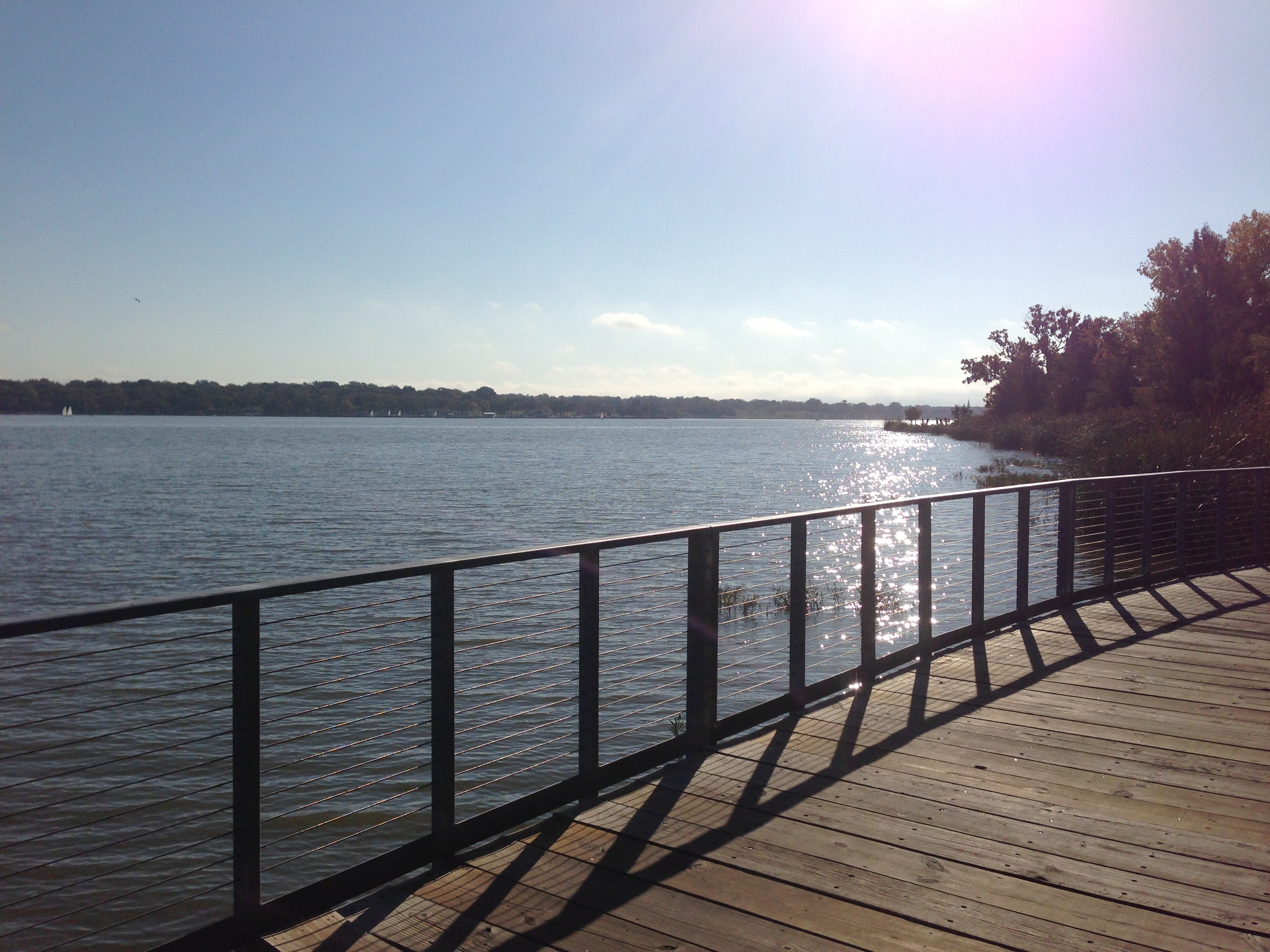 White Rock Lake trail in Dallas Texas showing cyclists and joggers on the 9.33-mile perimeter loop around the urban reservoir