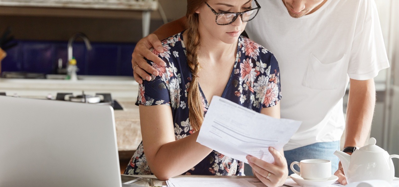 Couple recording and organizing their transactions