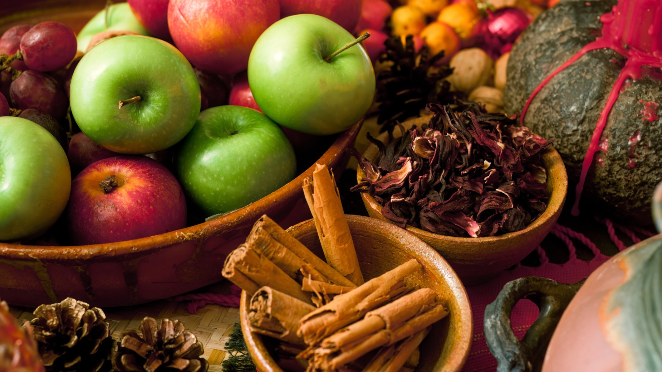 Photo image of apples, cinnamon sticks, and pinecones