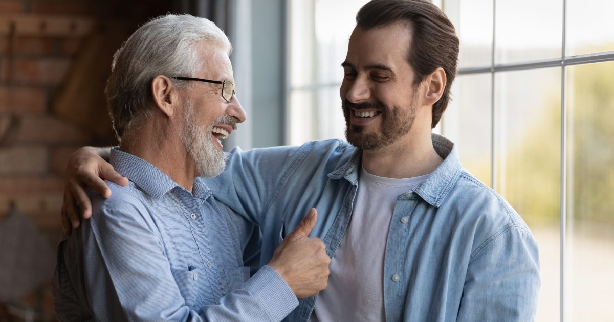 Dad embracing and hugging is grown son