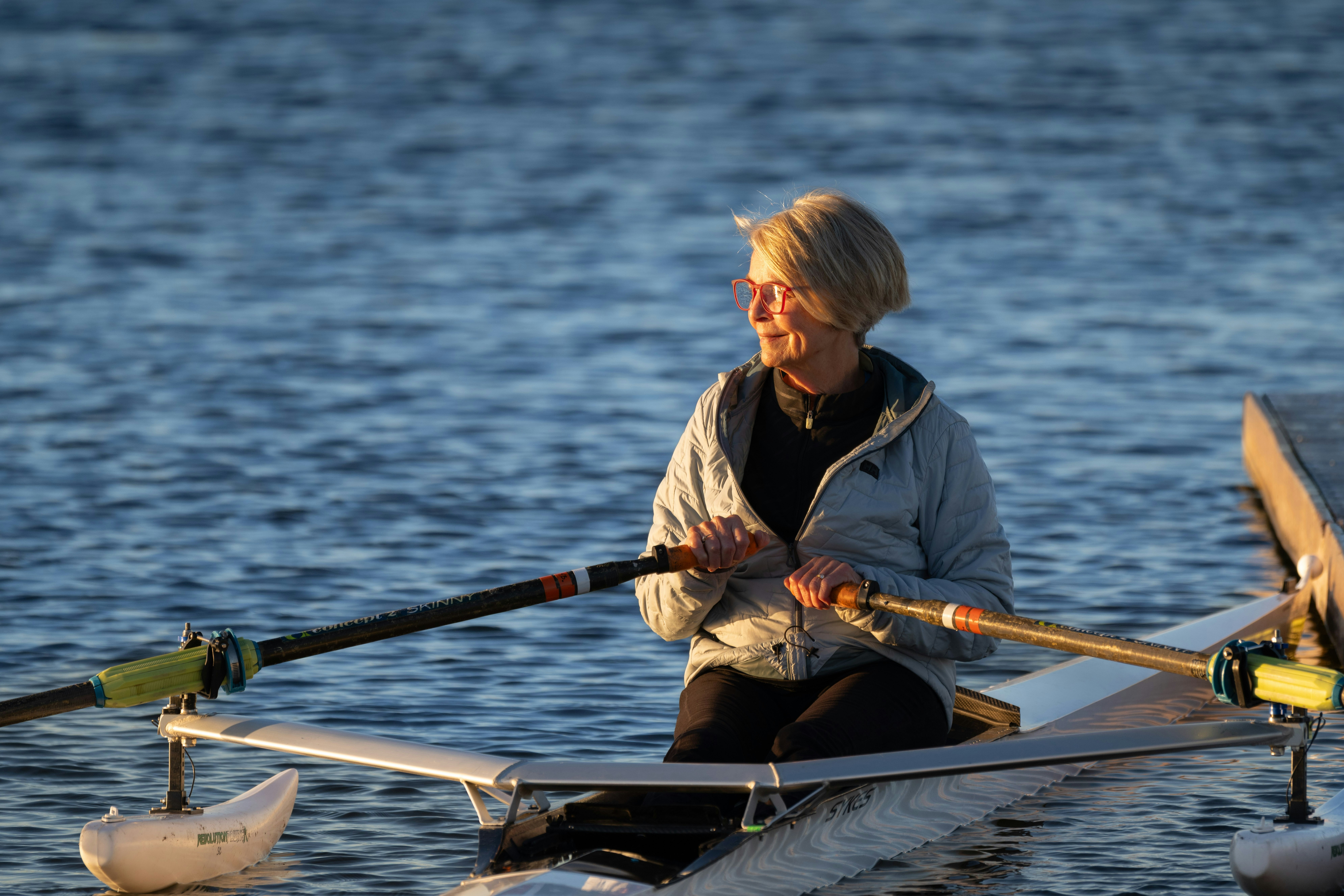 Woman rowing happily on the water
