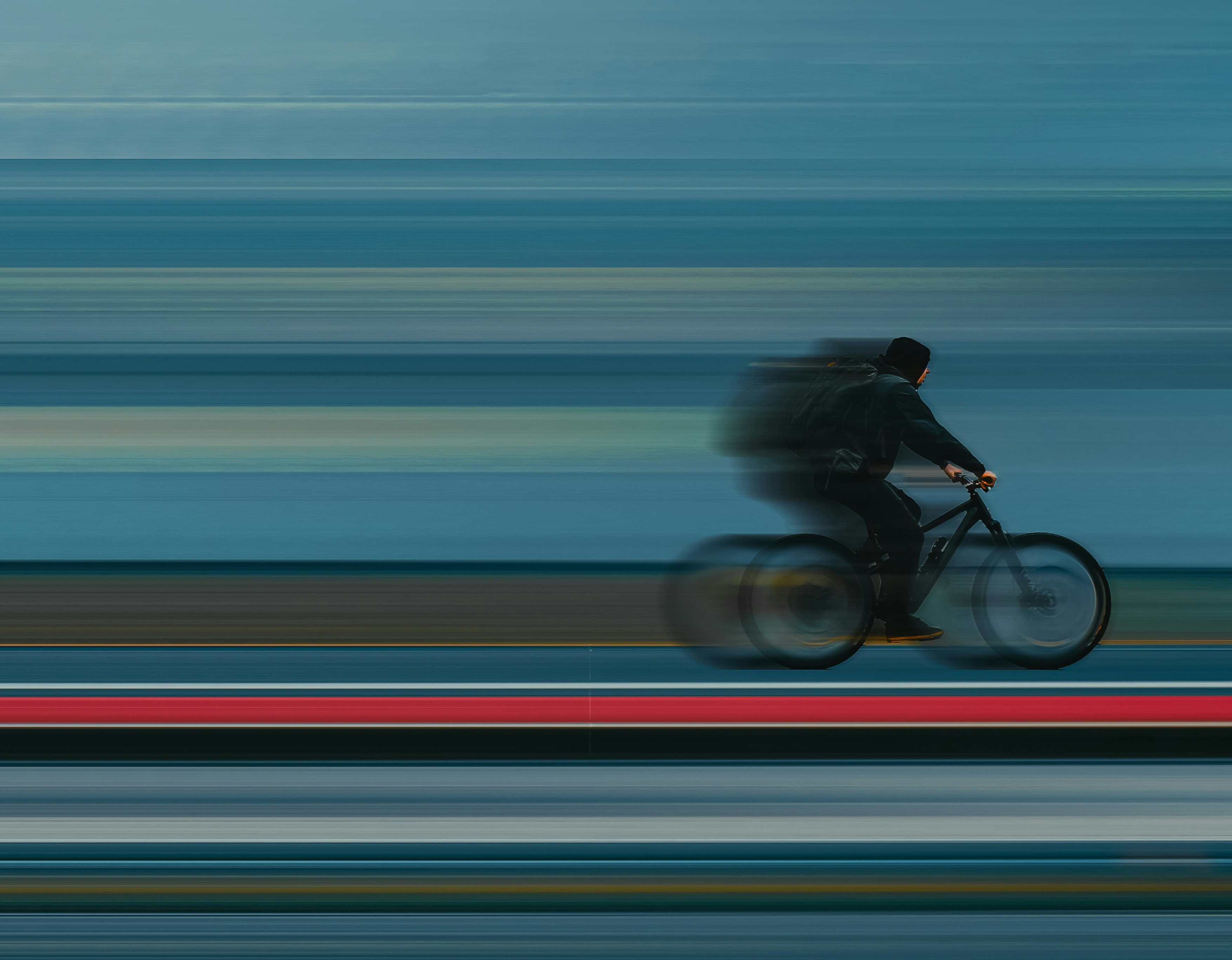 A cyclist riding very fast