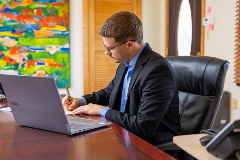 Michael at his desk wearing glasses