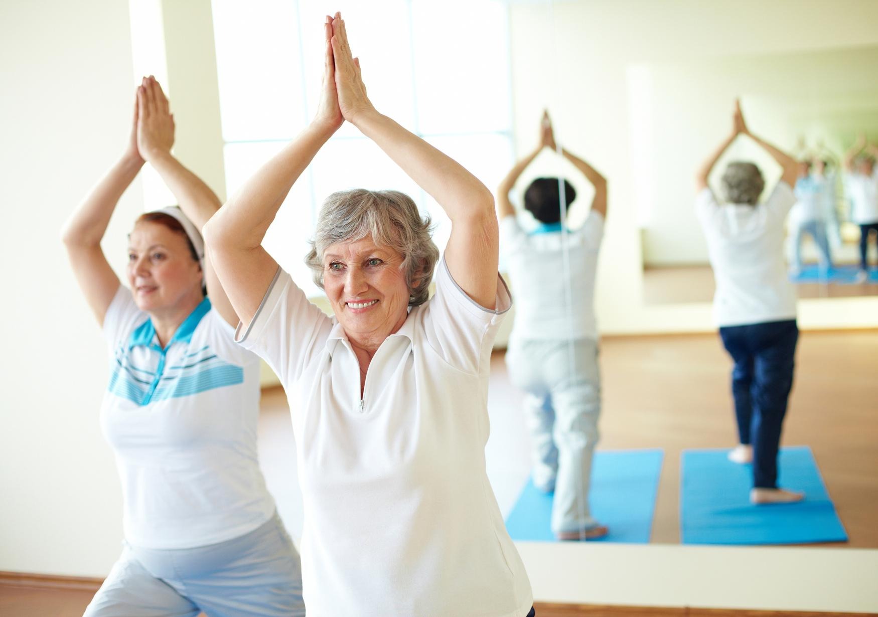 Women practicing yoga at the gym