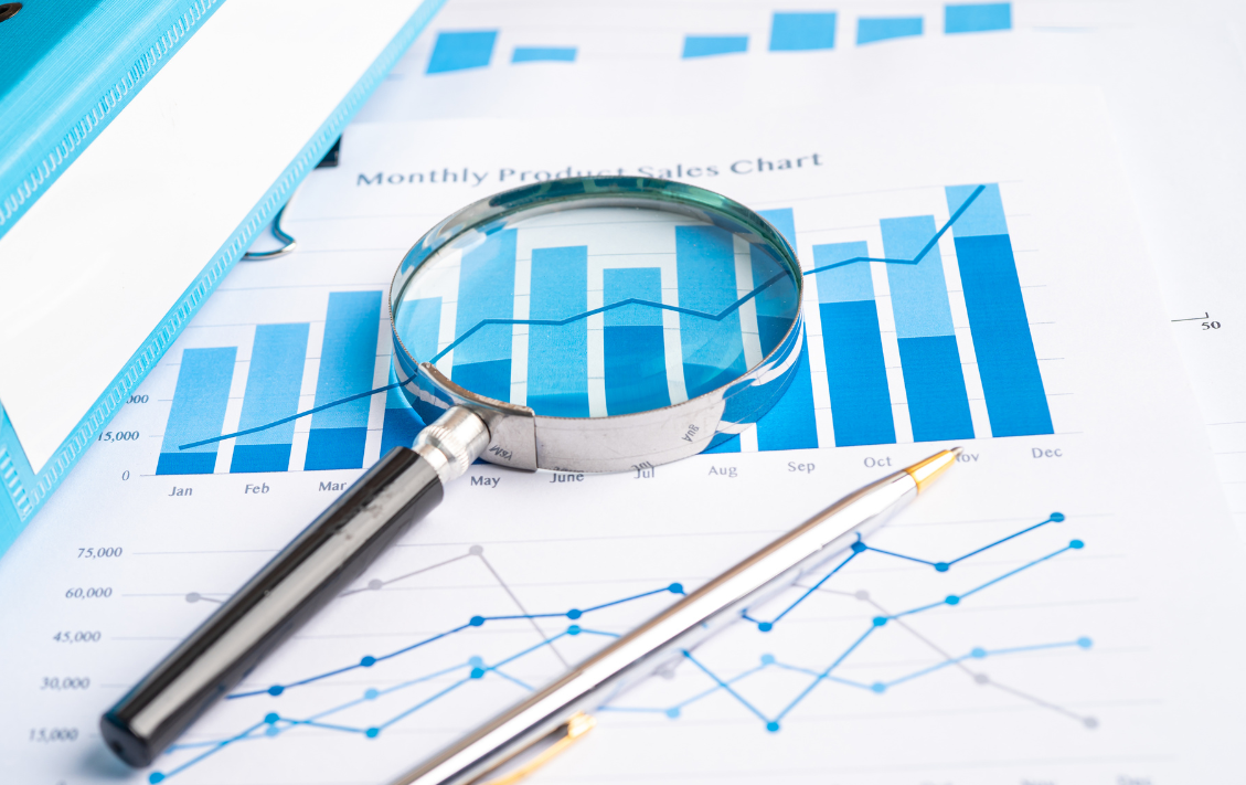 magnifying glass and graphs