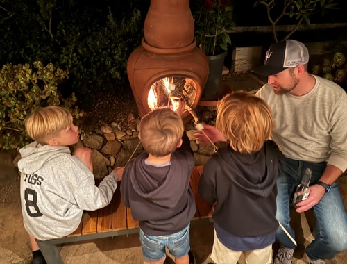 Casey and the nephews roasting marshmallows
