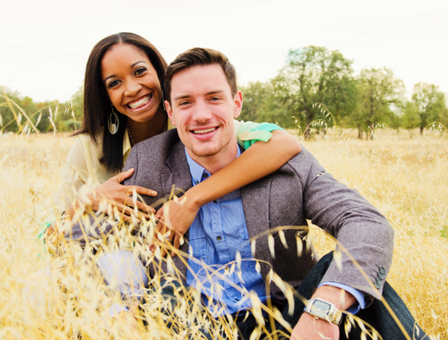 young interracial couple in field