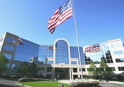 Building that Larson Financial Group resides in. There is an American flag blowing in the wind and can be seen reflected off the building.