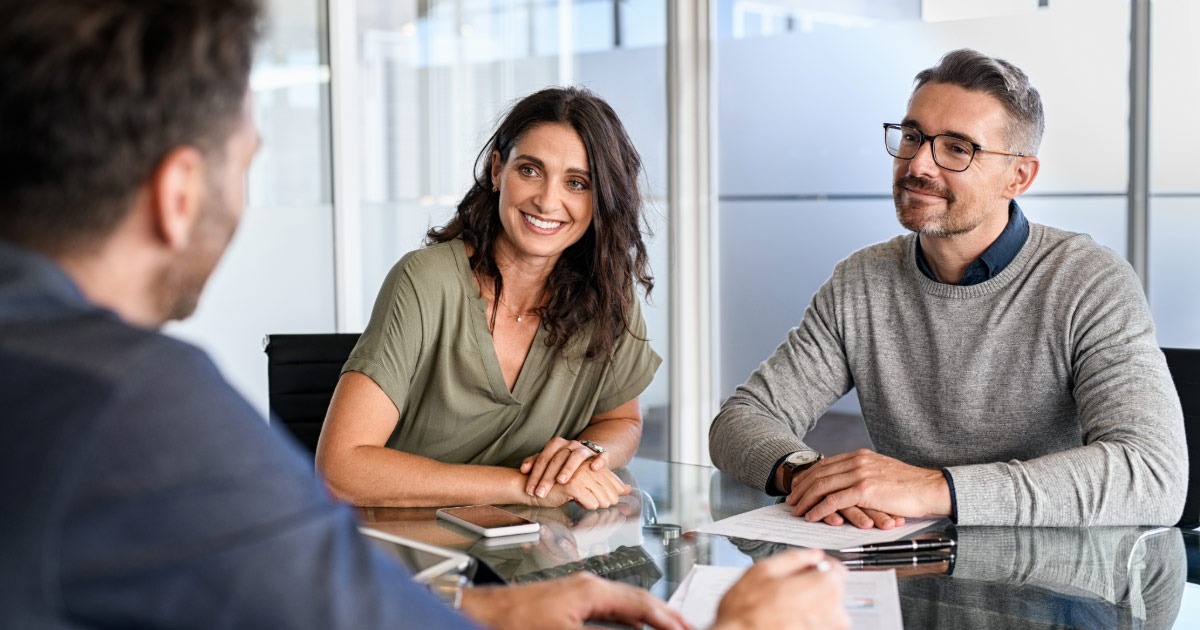 Middle-aged couple sitting with a financial counselor