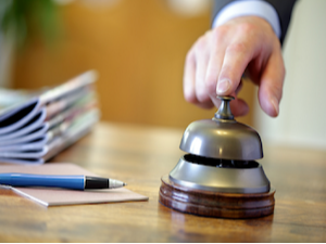 Person touching the desk bell.