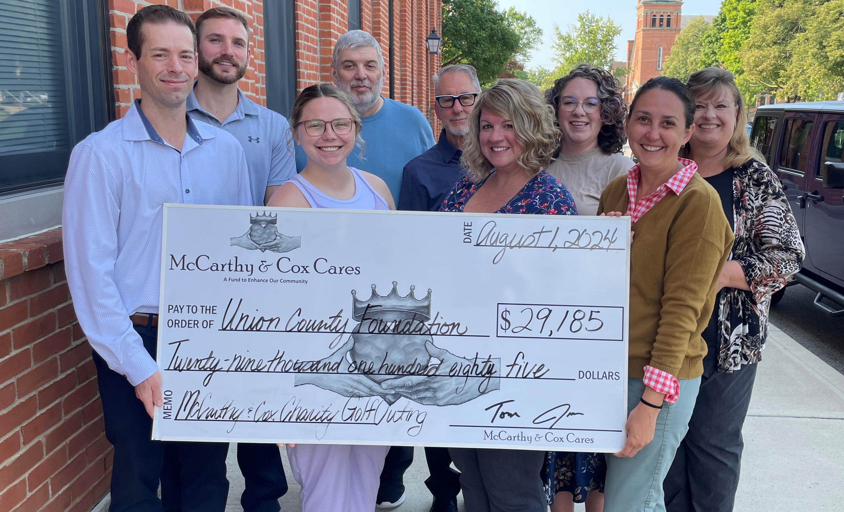 McCarthy and Cox Cares team holding a giant check for the Union County Foundation