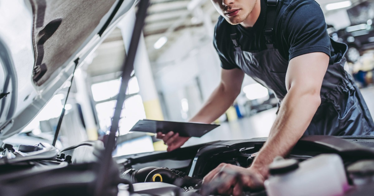 Mechanic looking over a car's engine bay