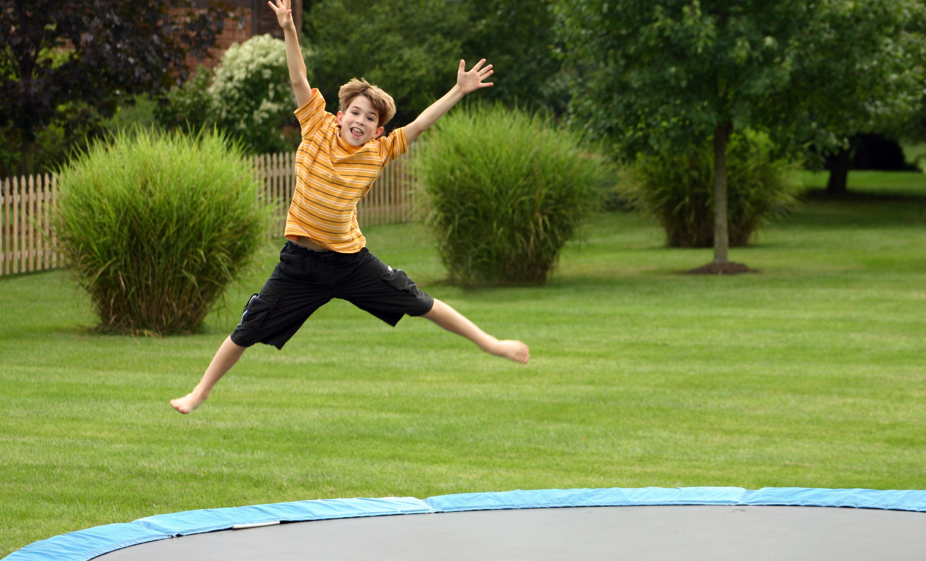 Photo of a boy jumping on a trampoline