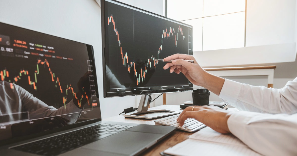Financial advisor reviewing stock prices on his computer