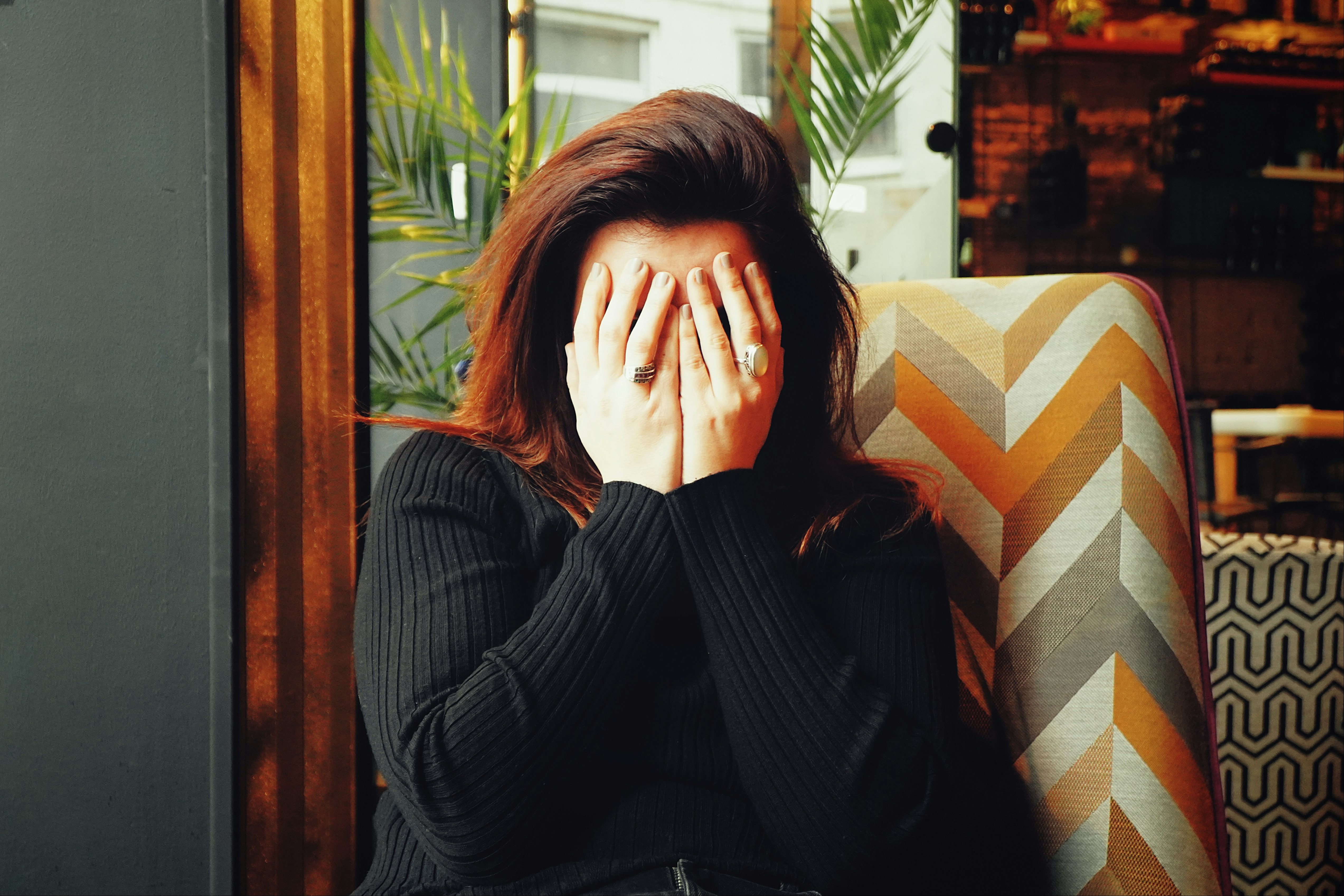 A woman stressed with her head in her hands