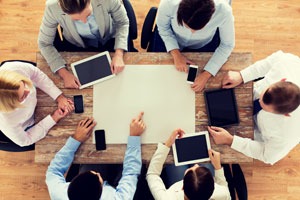 Business individuals engaged in discussion around a table