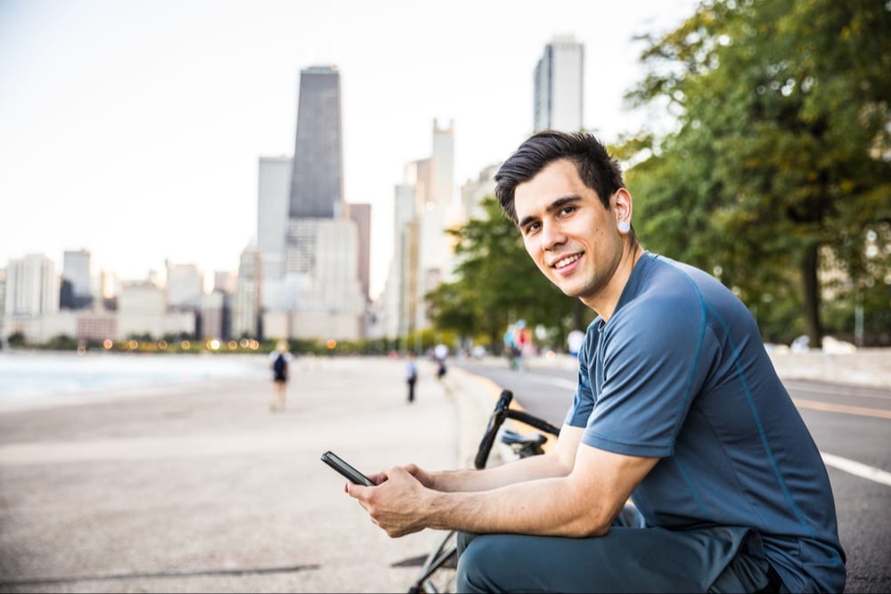 Man on phone next to river