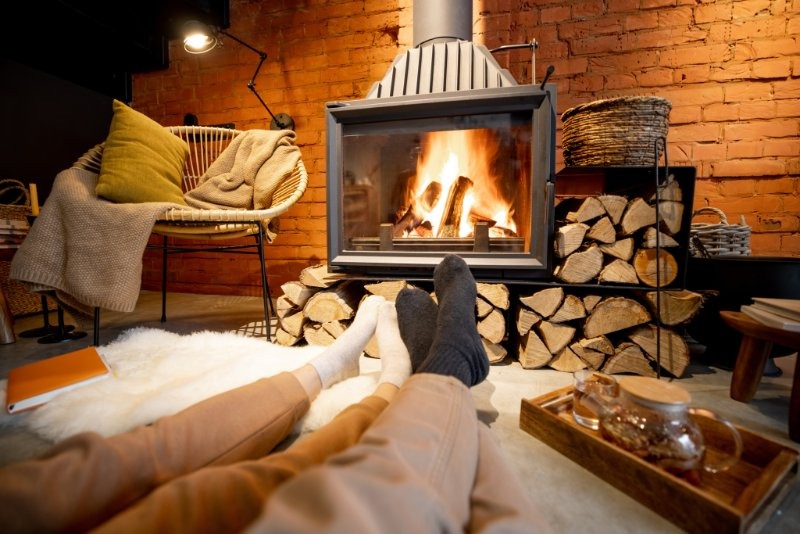cozy couple in front of wood stove