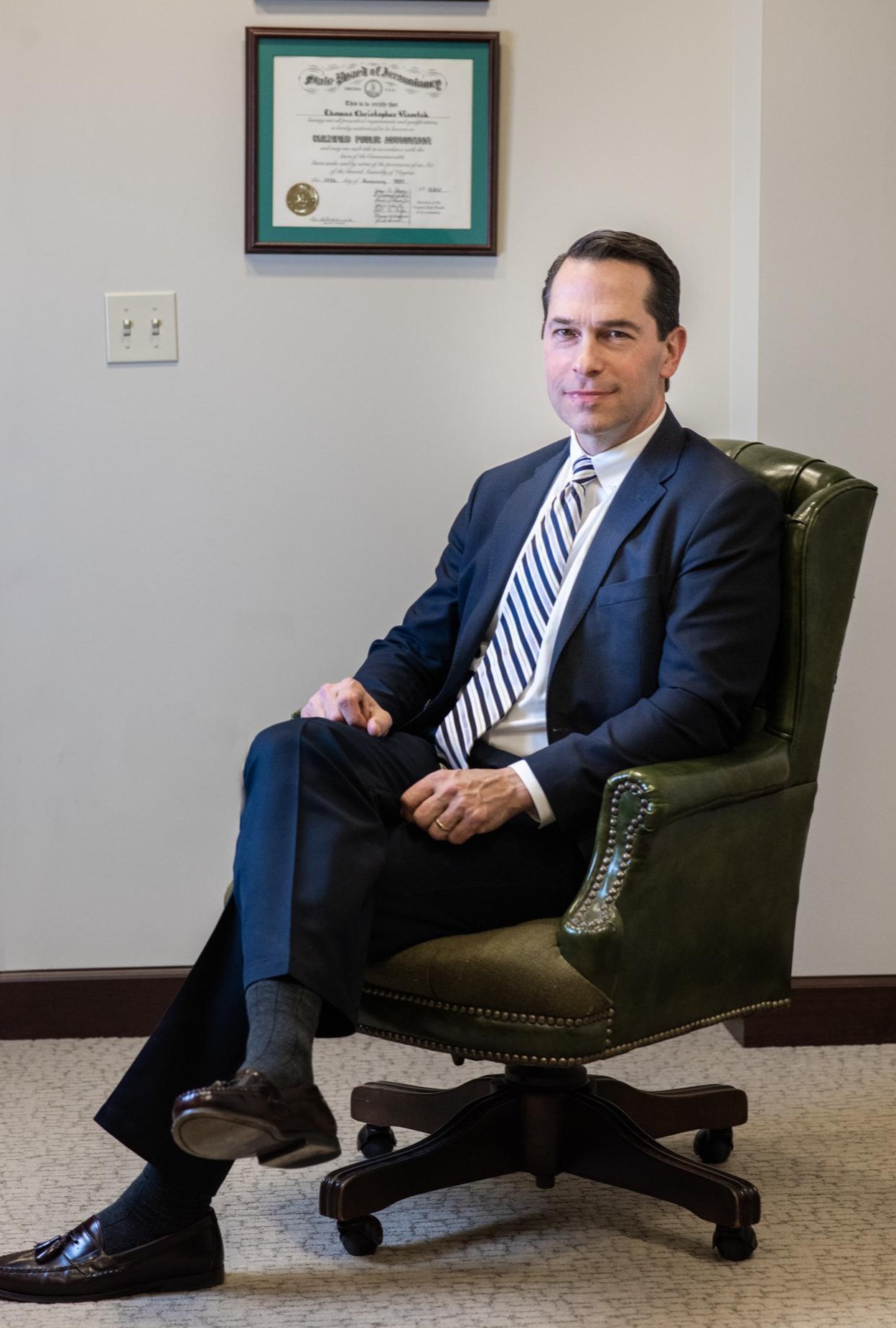 Tom in front of an award