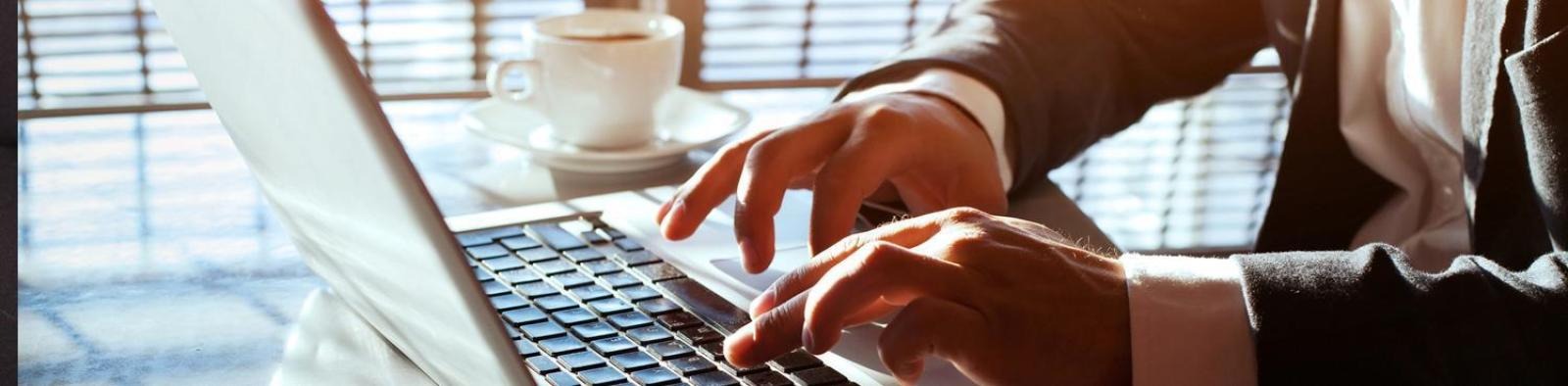 person typing on a laptop