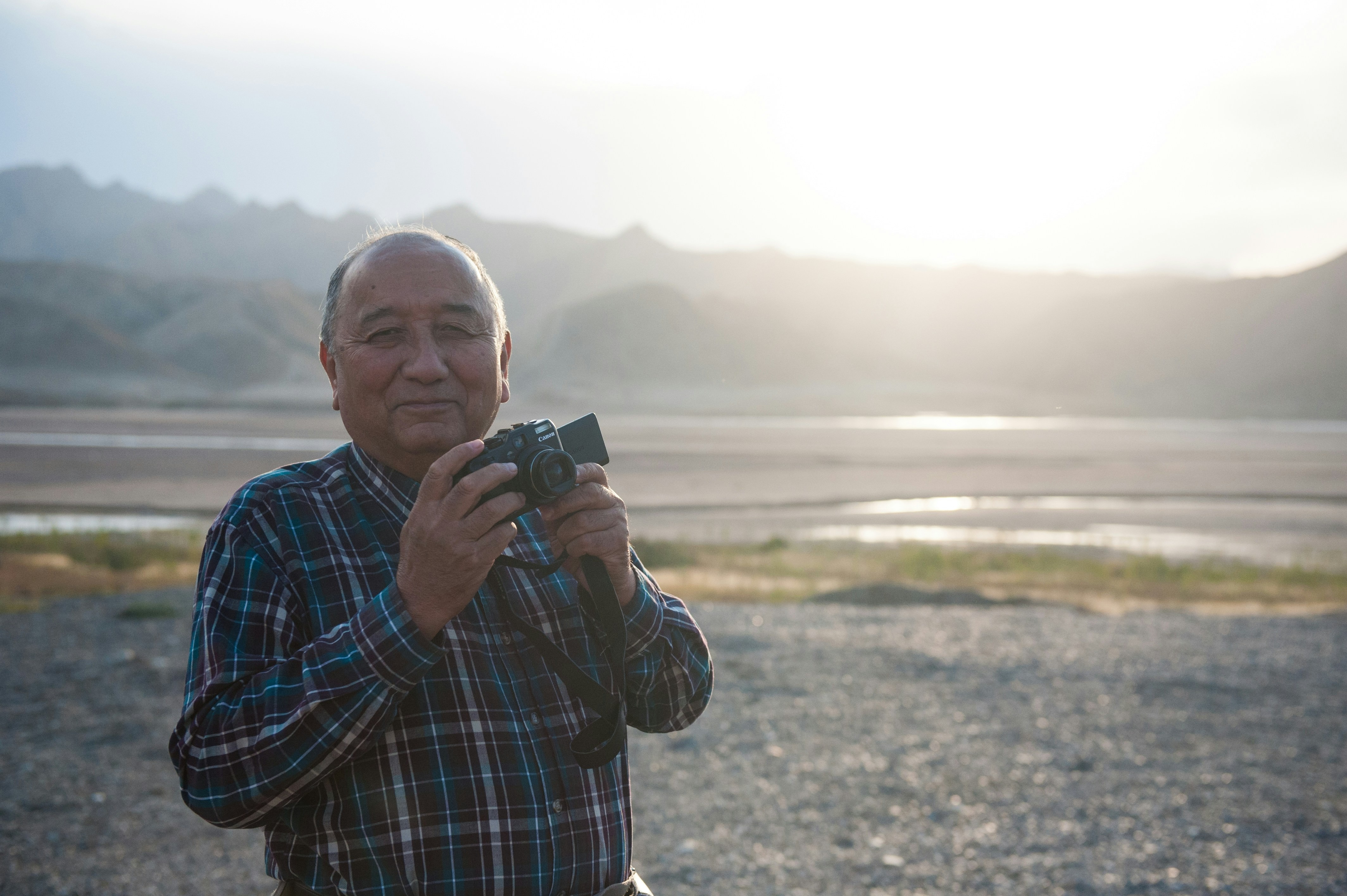 Happy man taking a photo of nature