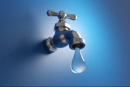a large drop of water coming out of a faucet