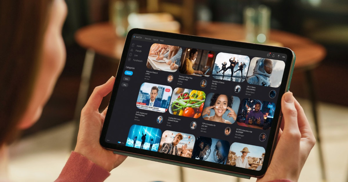 Woman holding up tablet with streaming service options on screen