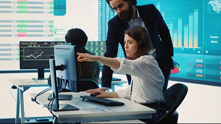 Two people looking at computer screen