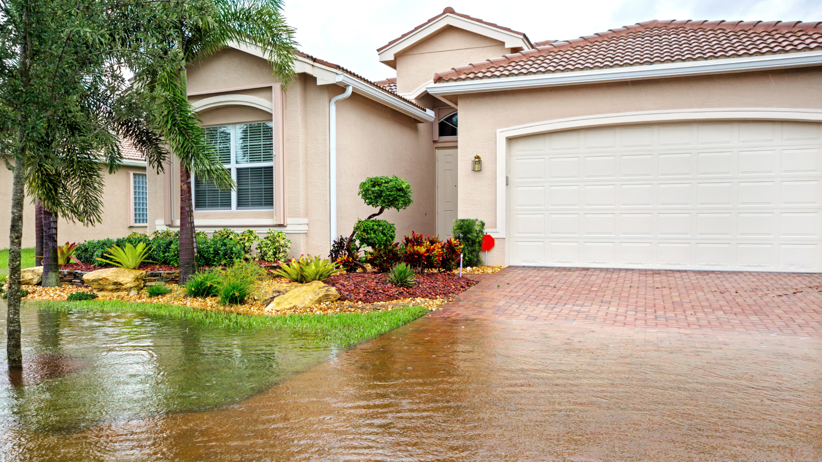 Photo of the exterior of a house experiencing flooding