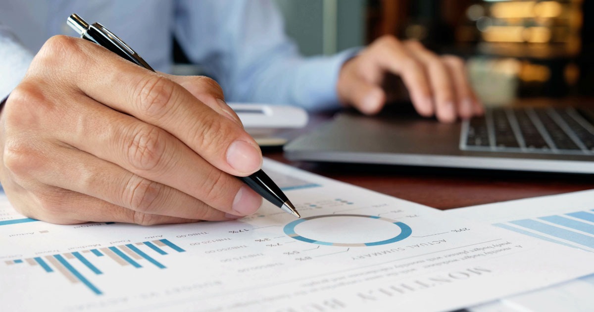 Man using chargs and laptop for financial planning