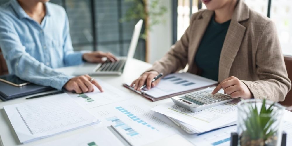 Financial professionals reviewing charts and calculations