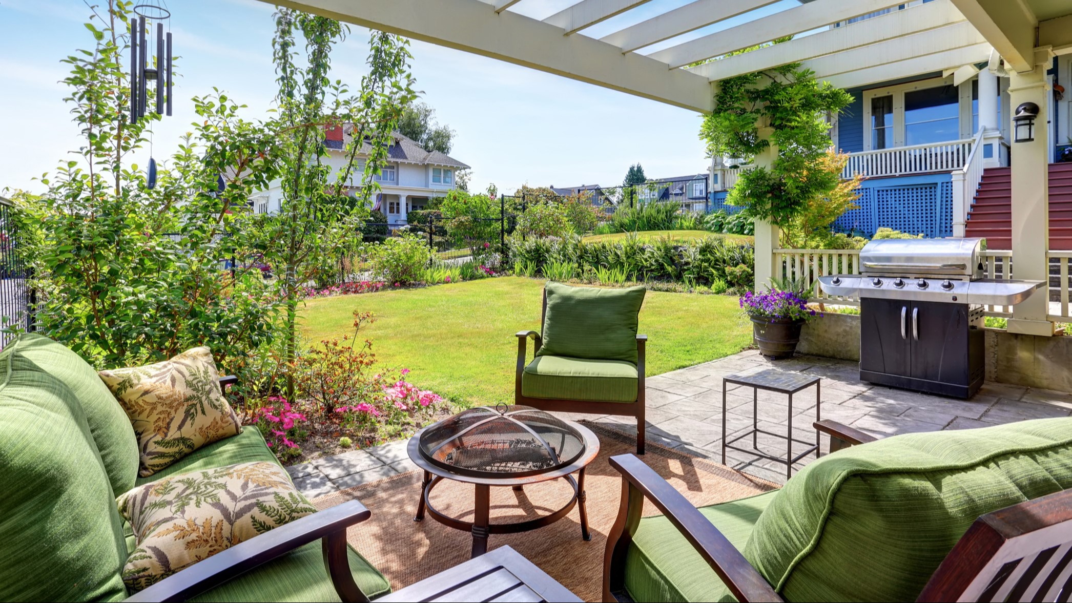 Photo image of a backyard area with seating and a bbq grill