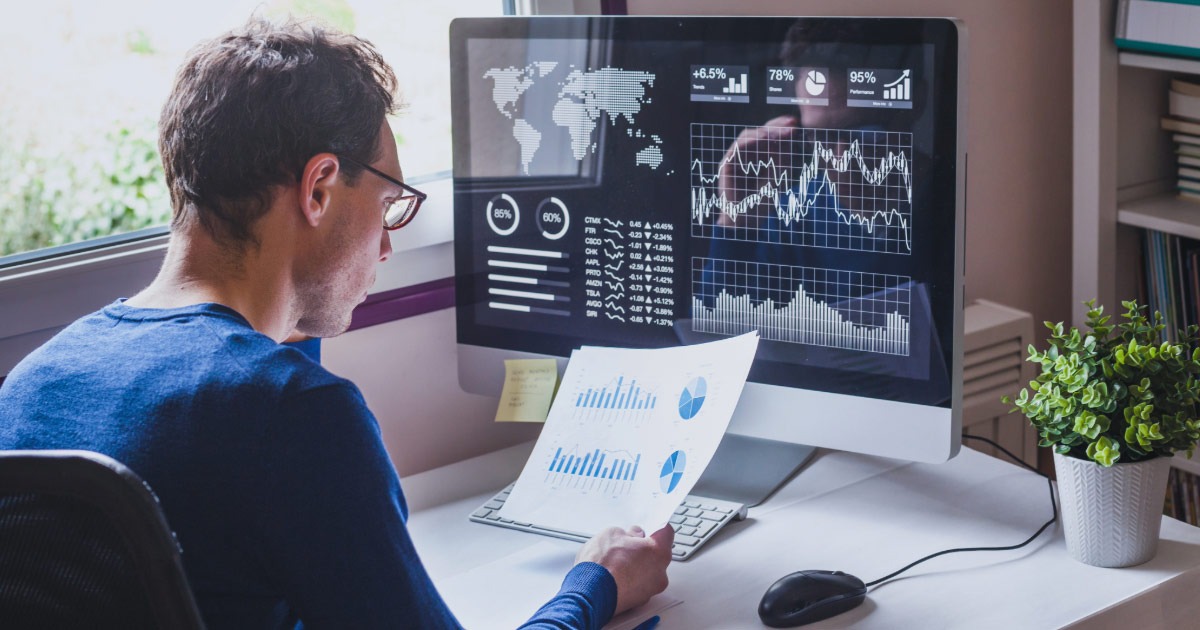 Middle-aged man looking at financial reports in his home office