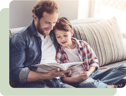 Father reading book to son