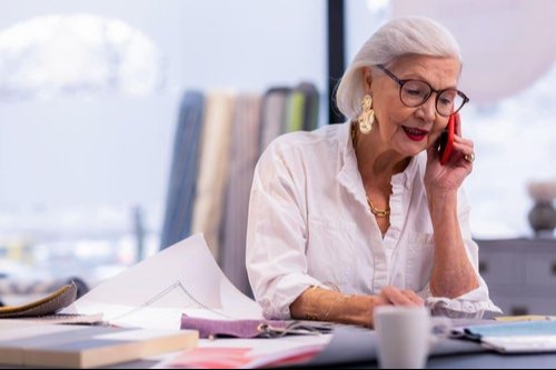 woman in an office talking on a cell phone