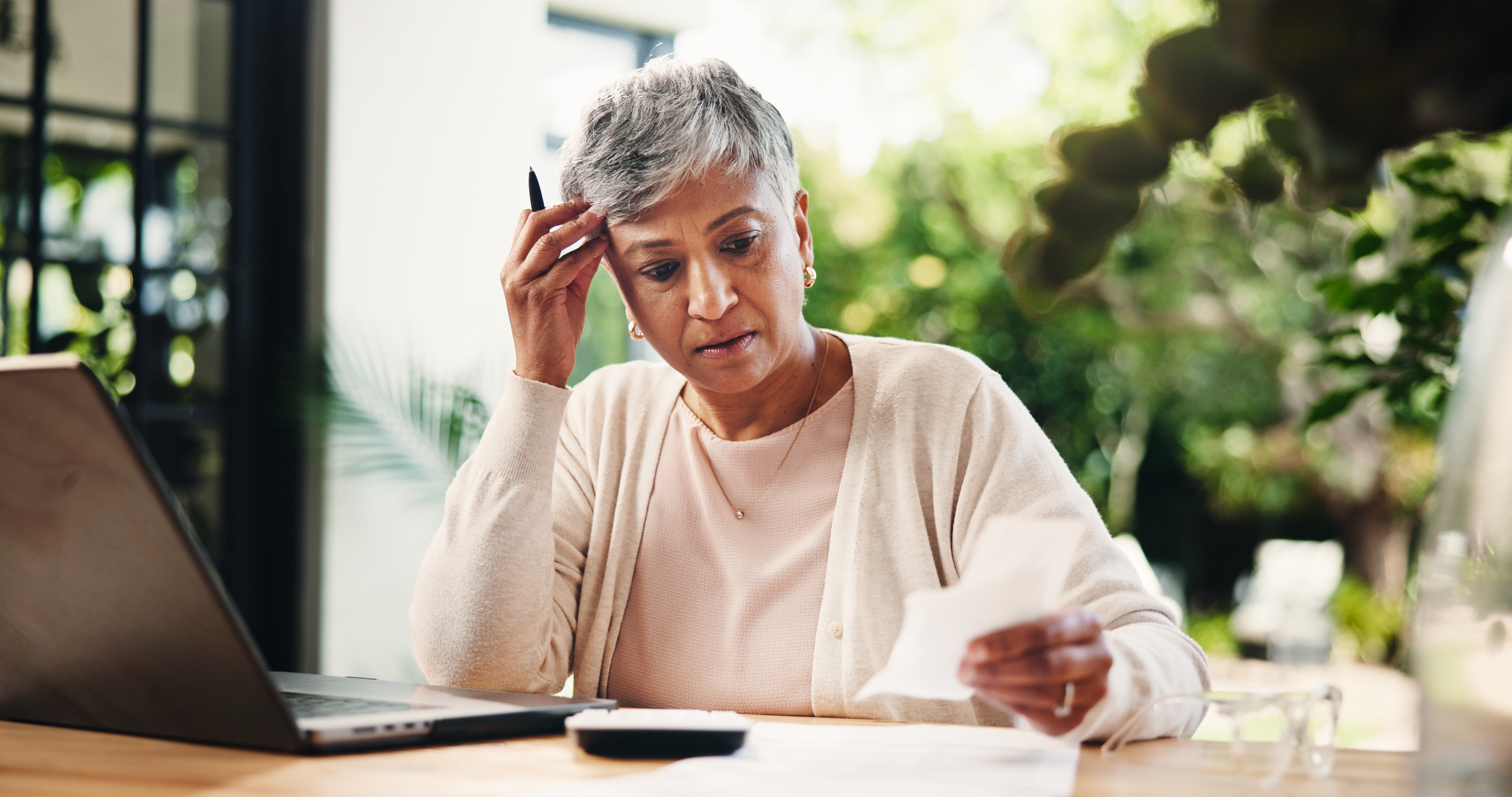 Widow reviewing financial documents at home