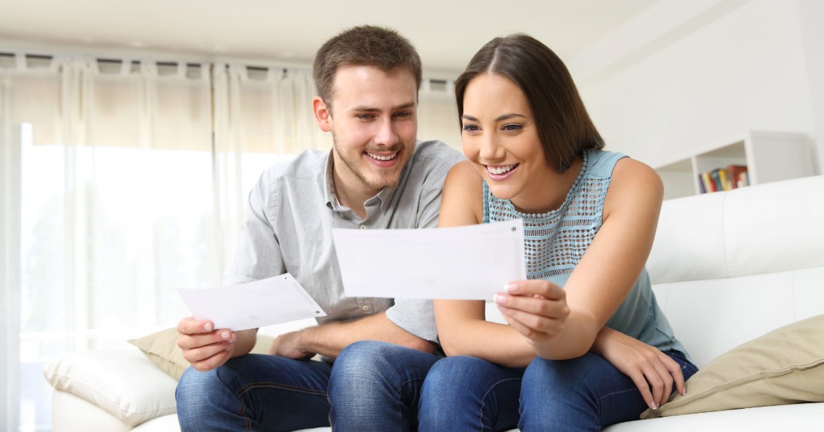 Young couple reviewing pay stubs together