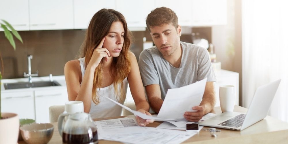 Couple reviewing financial documents at home