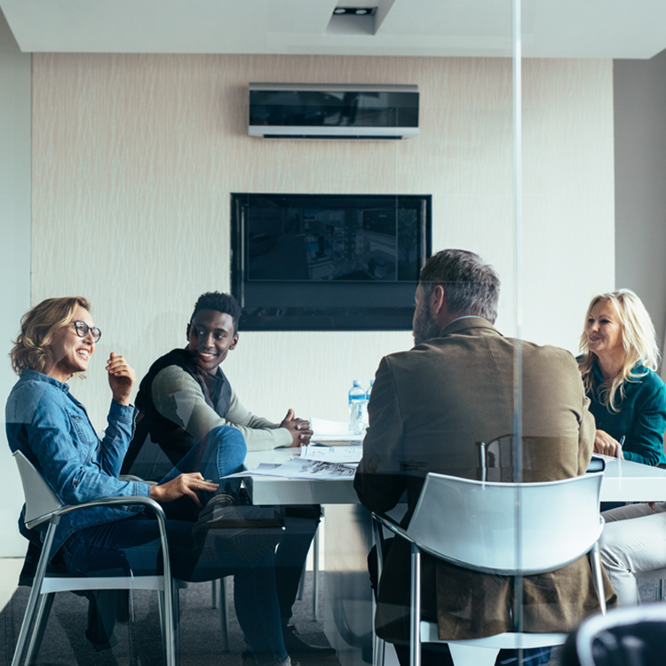 4 young adults working in a meeting room