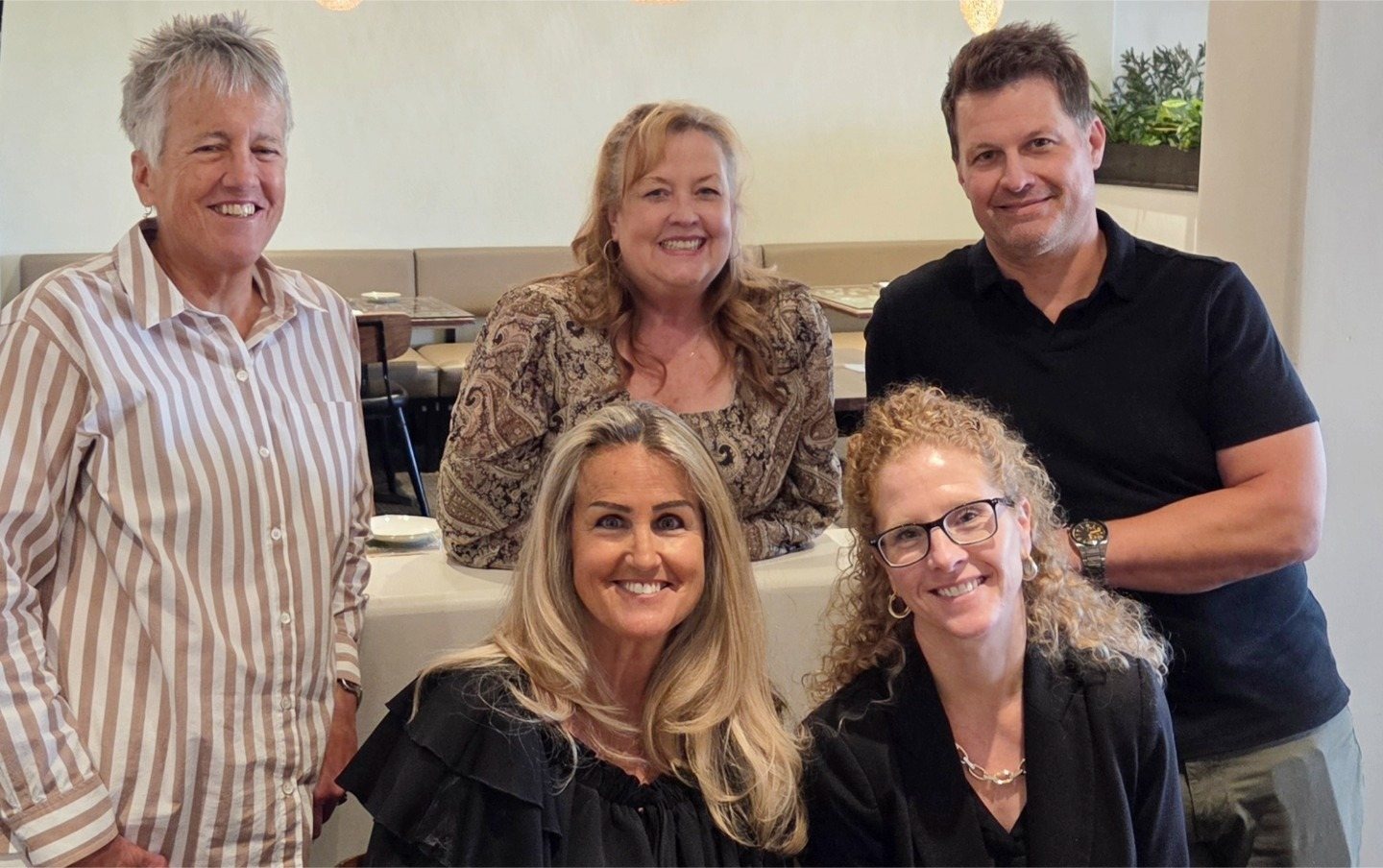 Five members of the SWP team gathered around a restaurant table