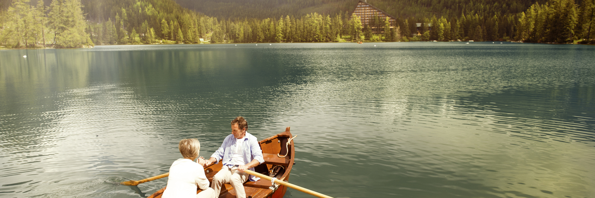 couple in a row boat on a mountain lake