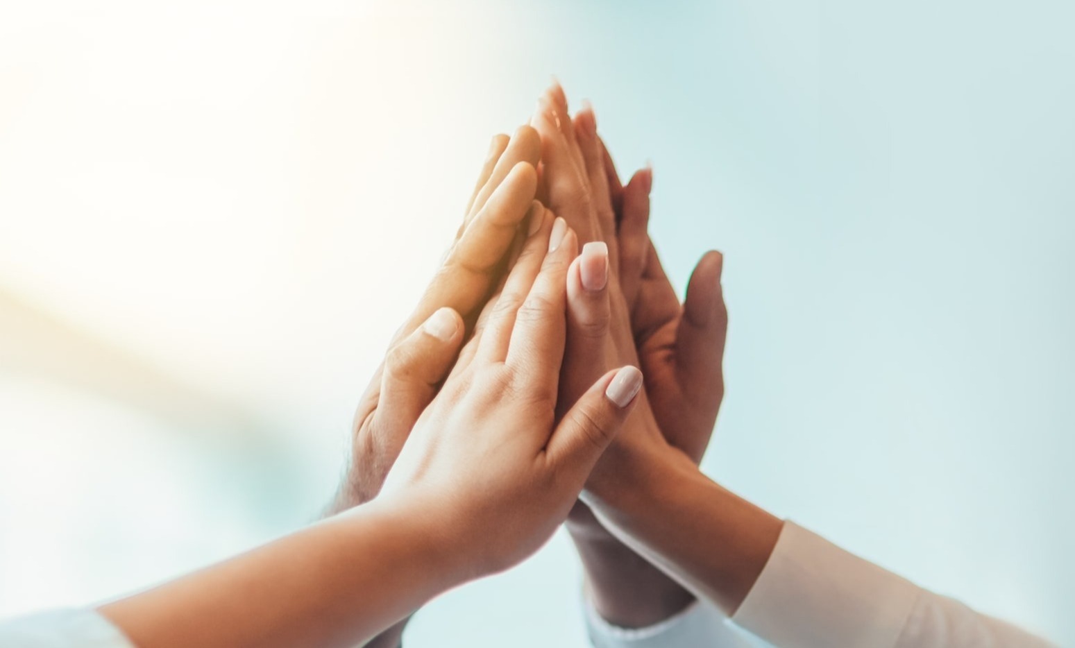 Two sets of hands raised in solidarity