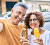 man and woman eating frozen treats