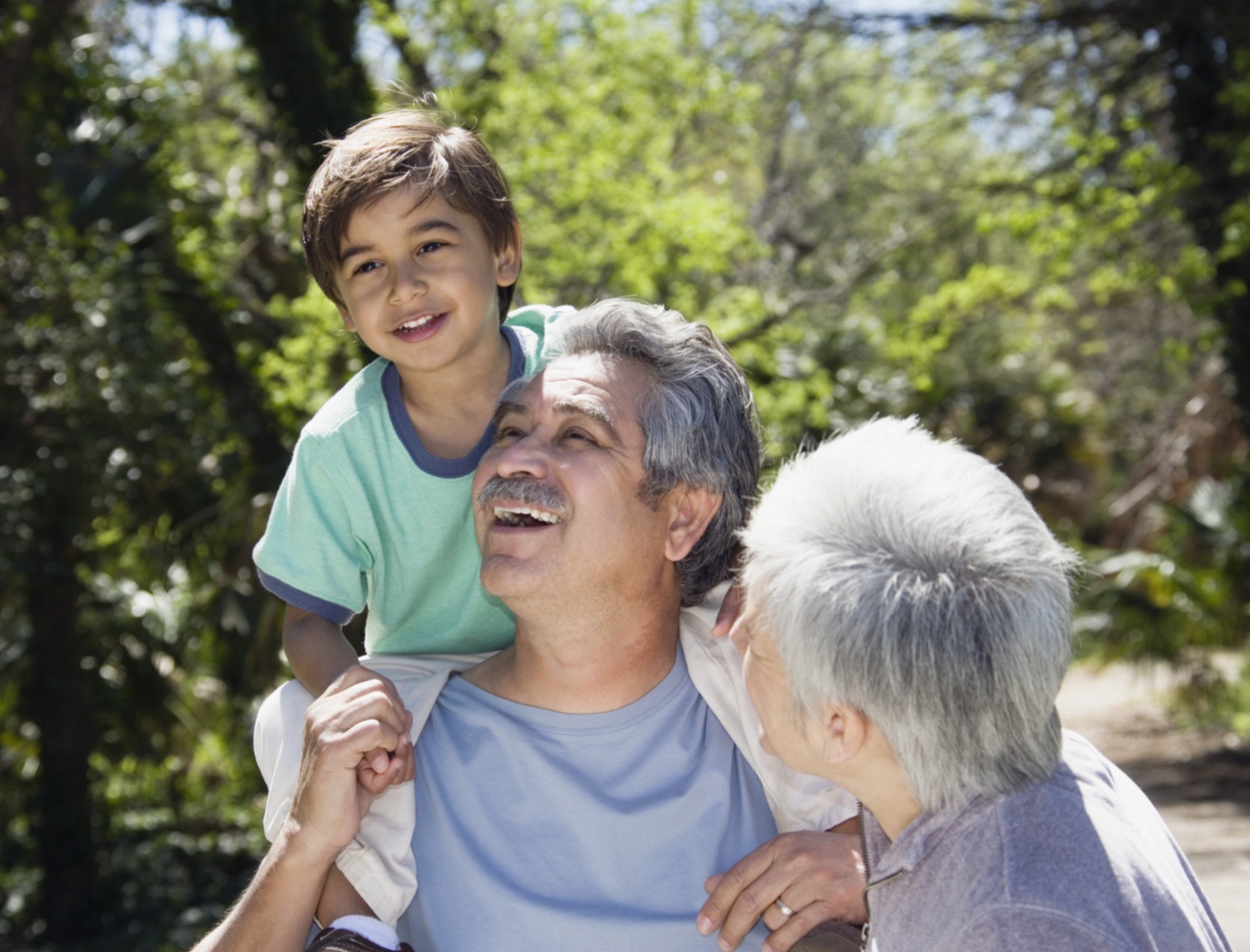 Grandparents playing outside with their grandson