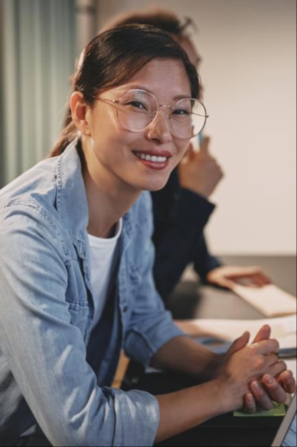 woman wearing glasses, attending a meeting